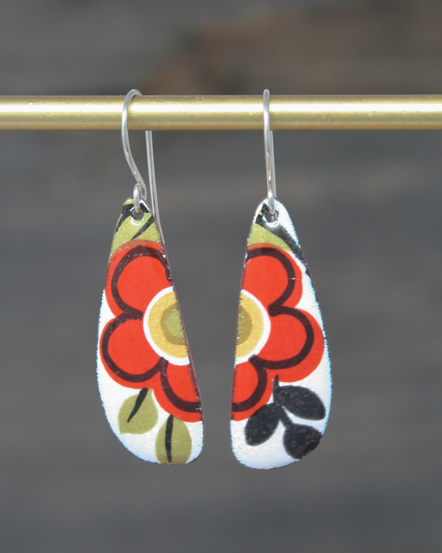 a pair of earrings hanging from a hook