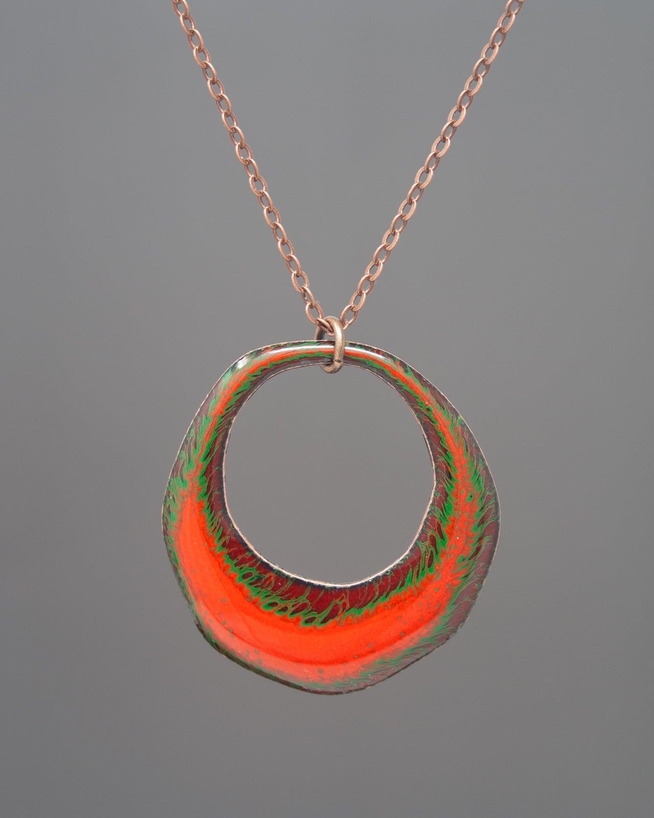 A necklace with a circular pendant featuring a vibrant, multicolored design.