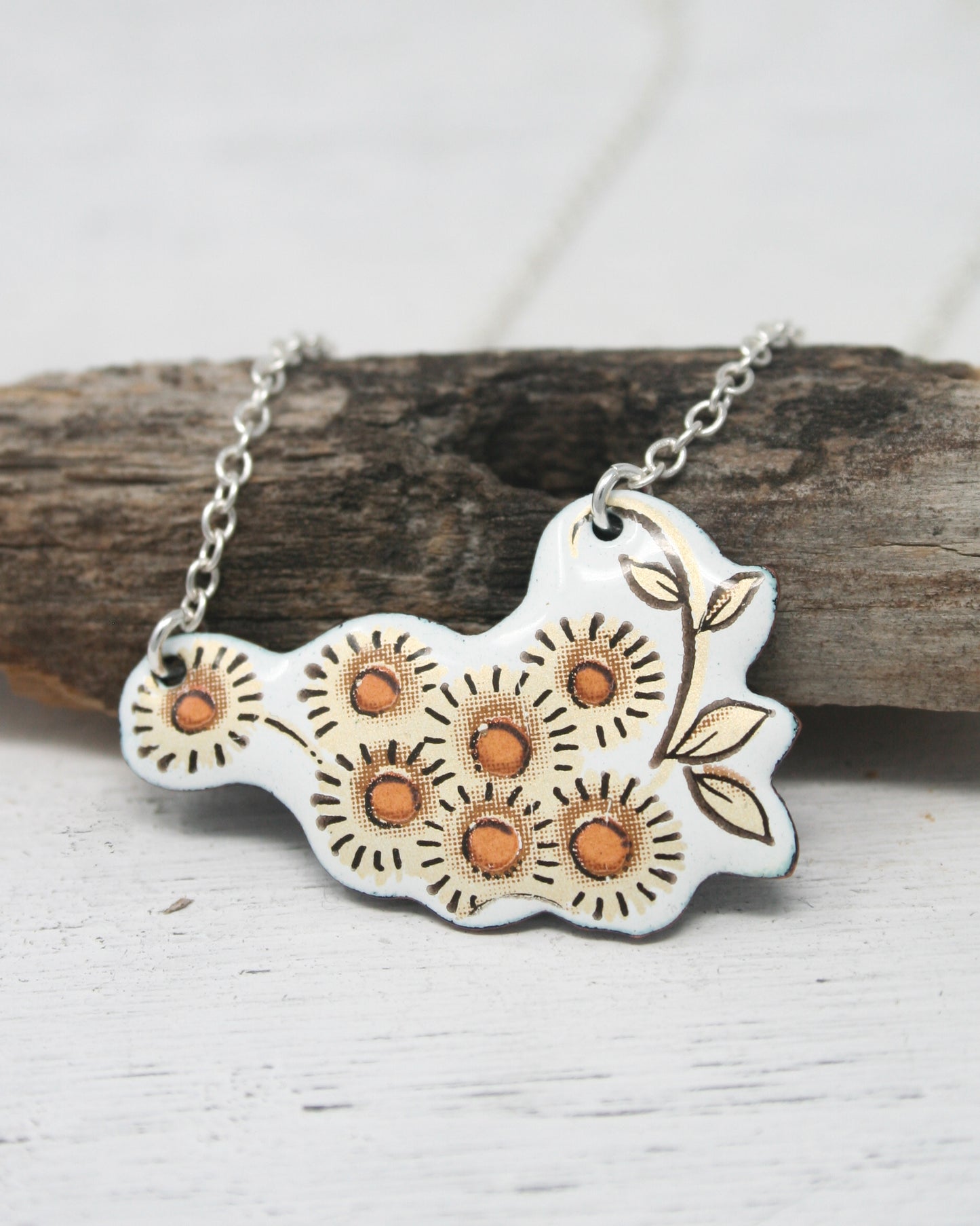 a necklace with a flower design on it