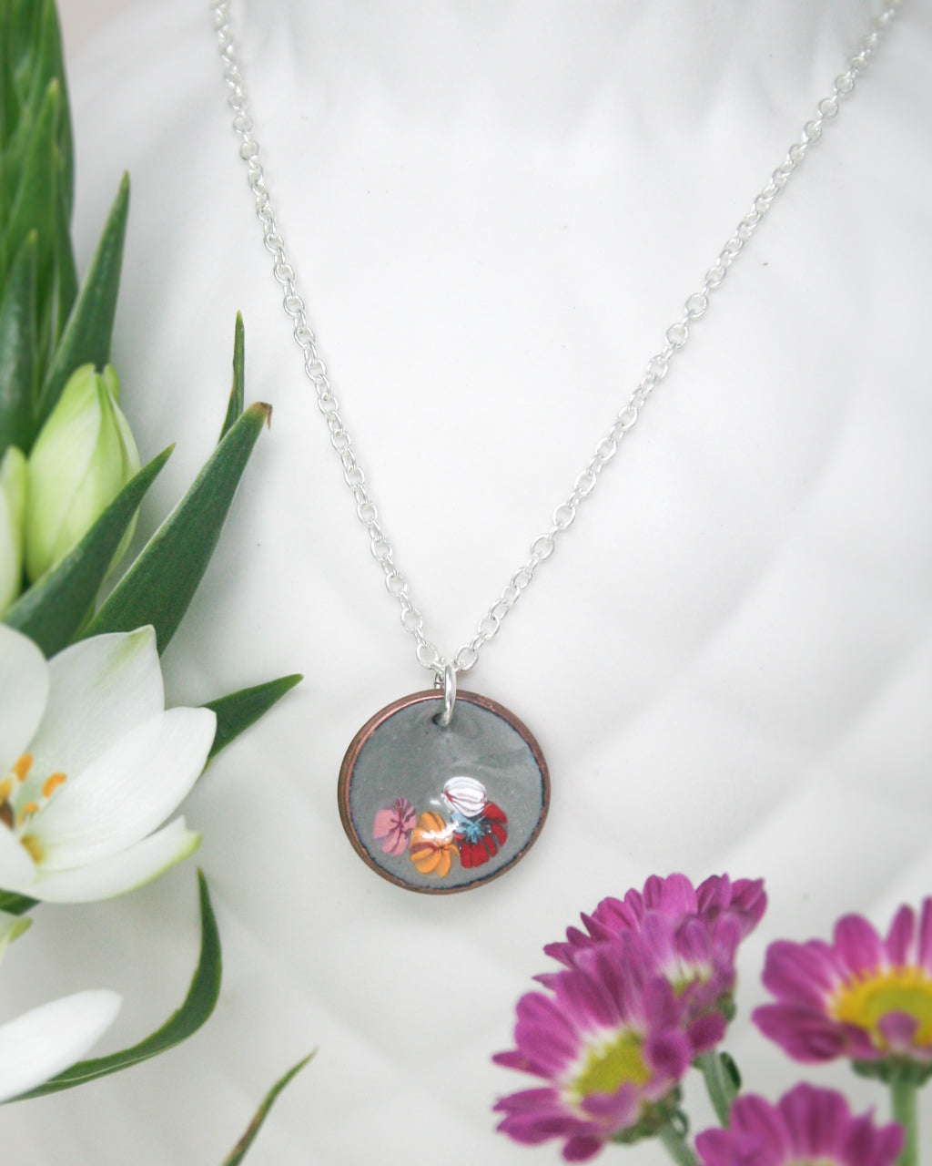 a necklace with a picture of a bird on it
