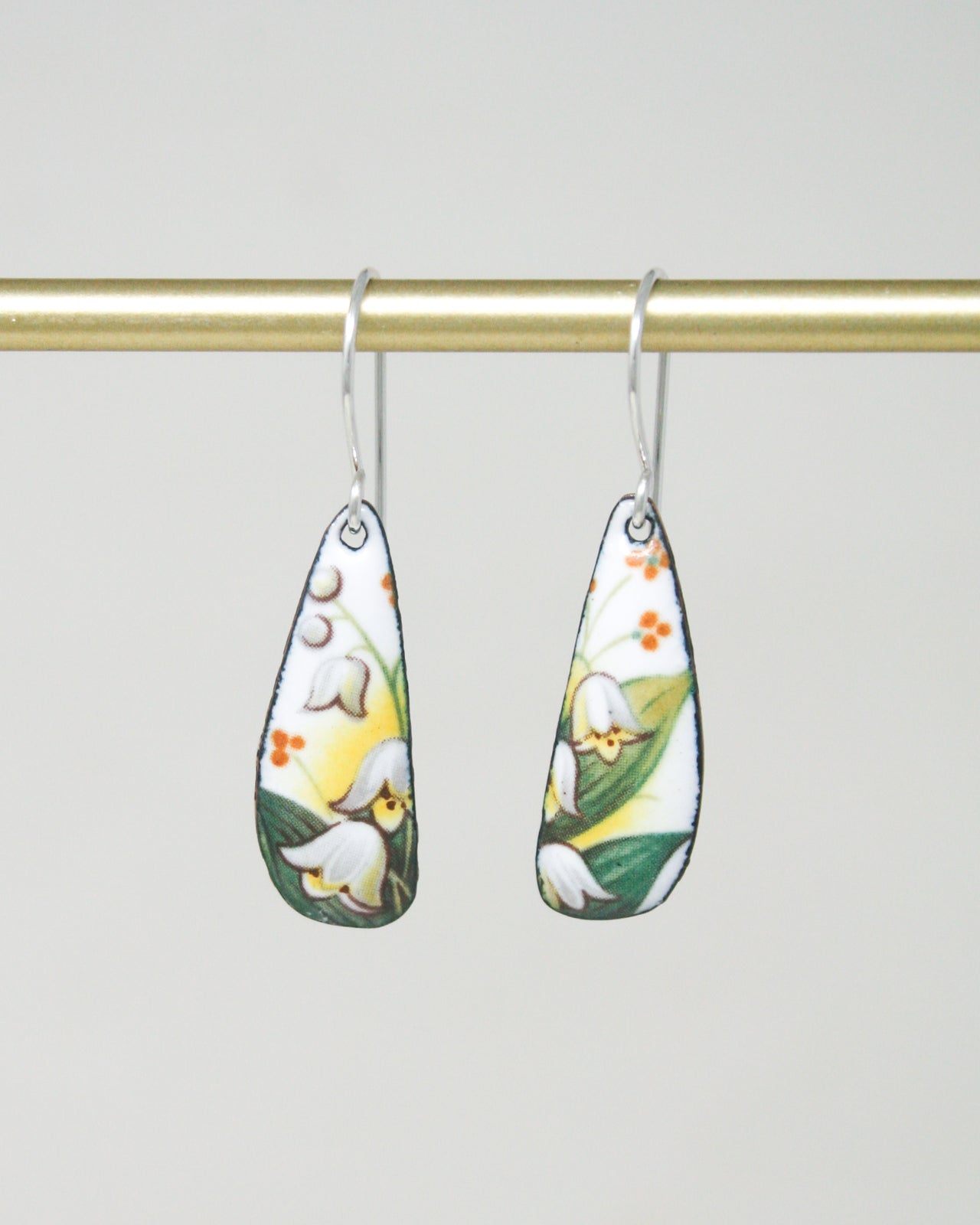 a pair of earrings hanging from a clothes line