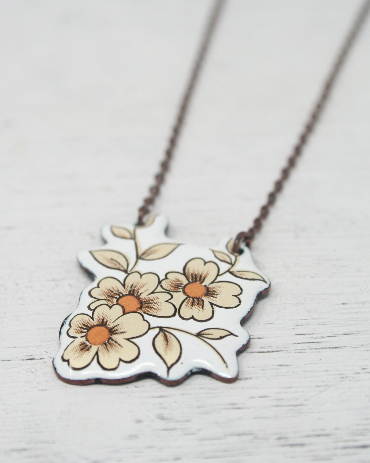 a necklace with flowers painted on it