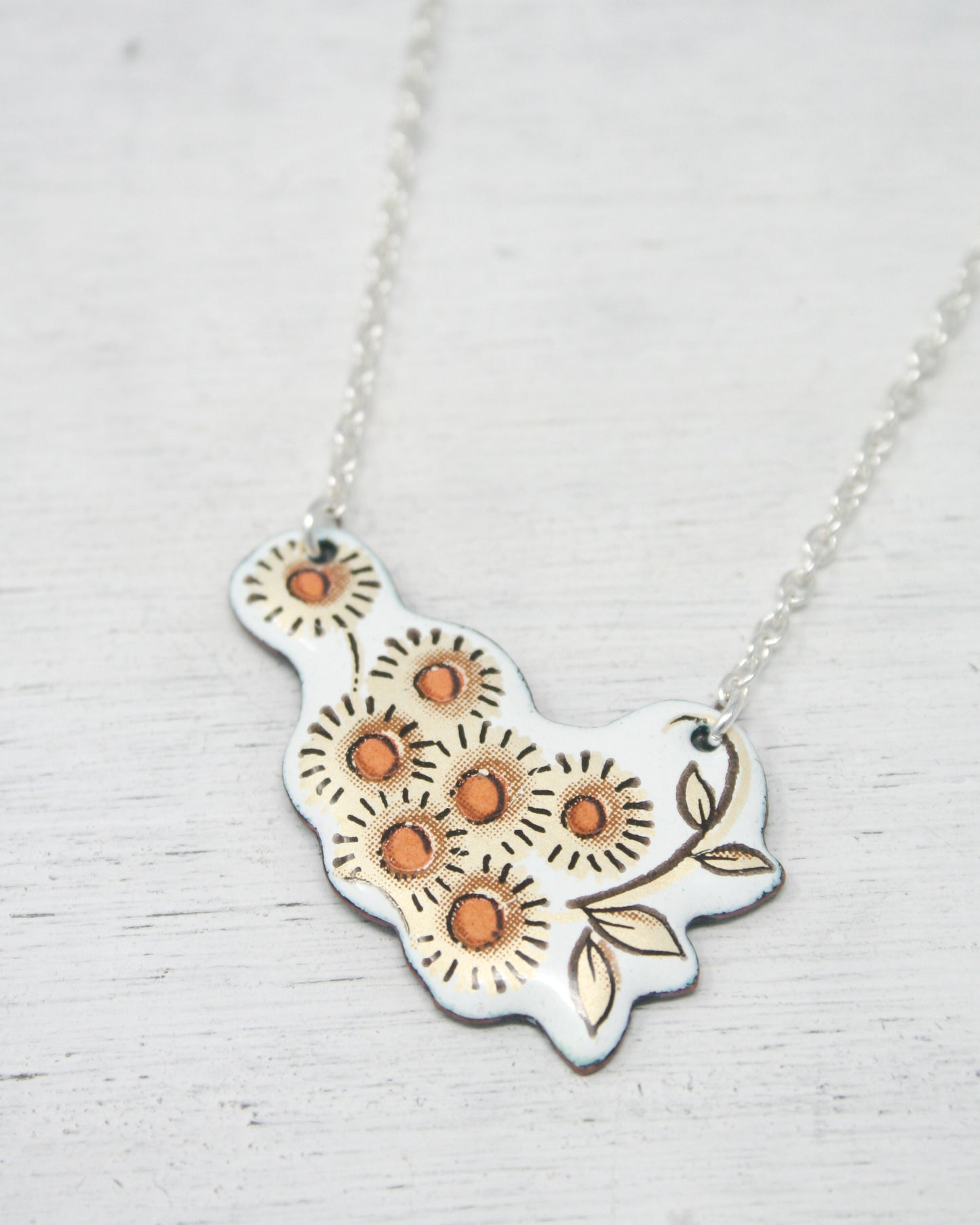 a necklace with a flower design on it