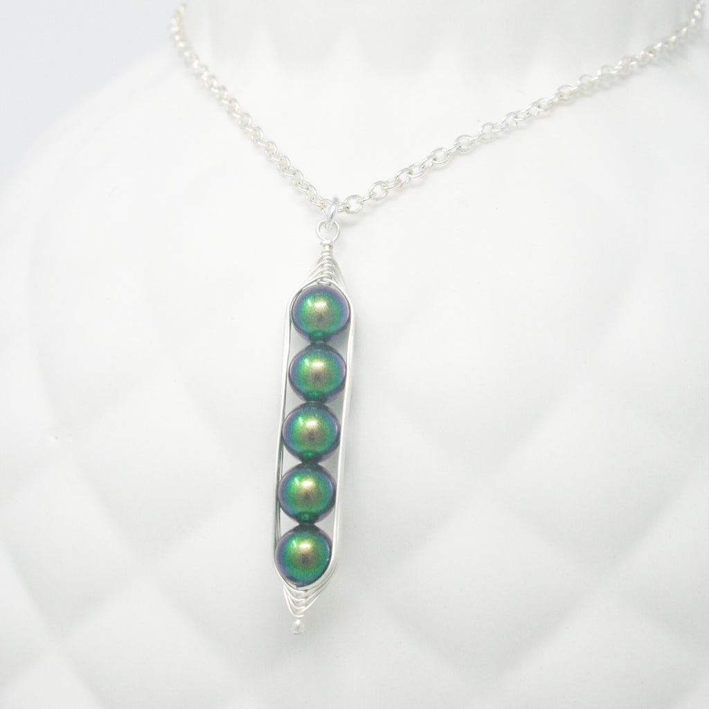 a green bead necklace on a silver chain