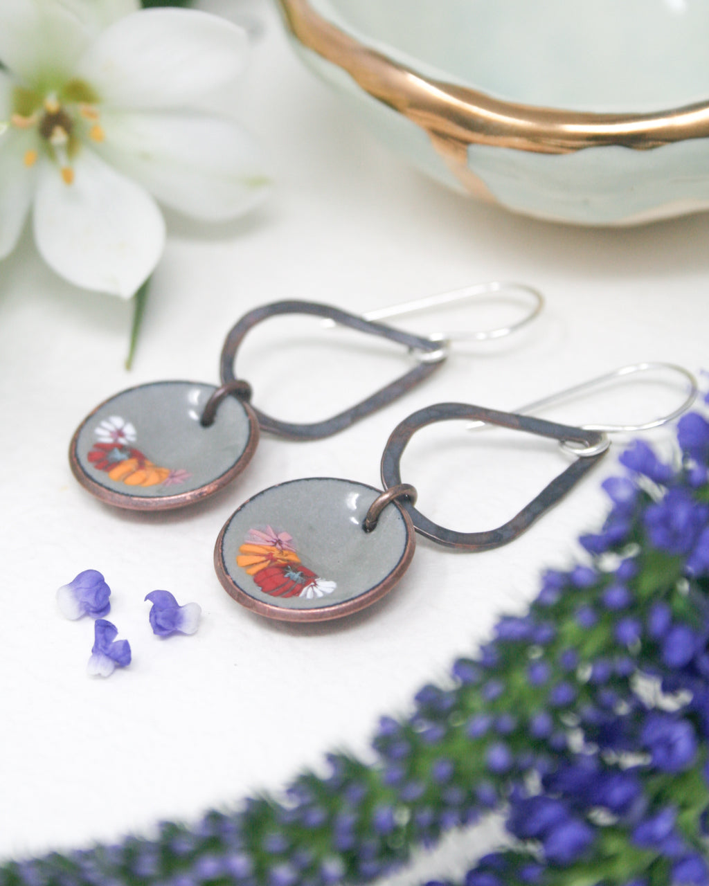 a pair of earrings sitting on top of a table