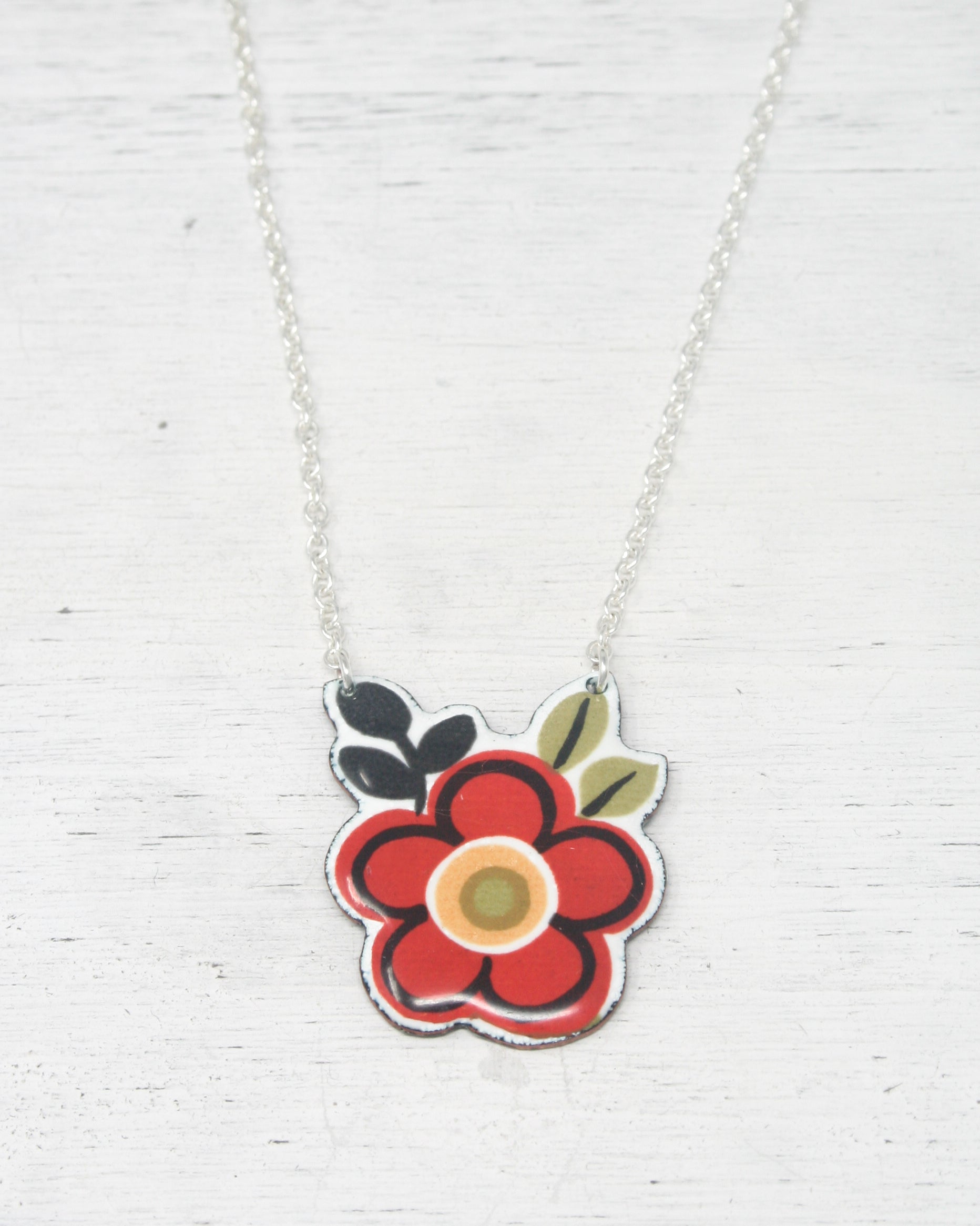 a necklace with a flower painted on it