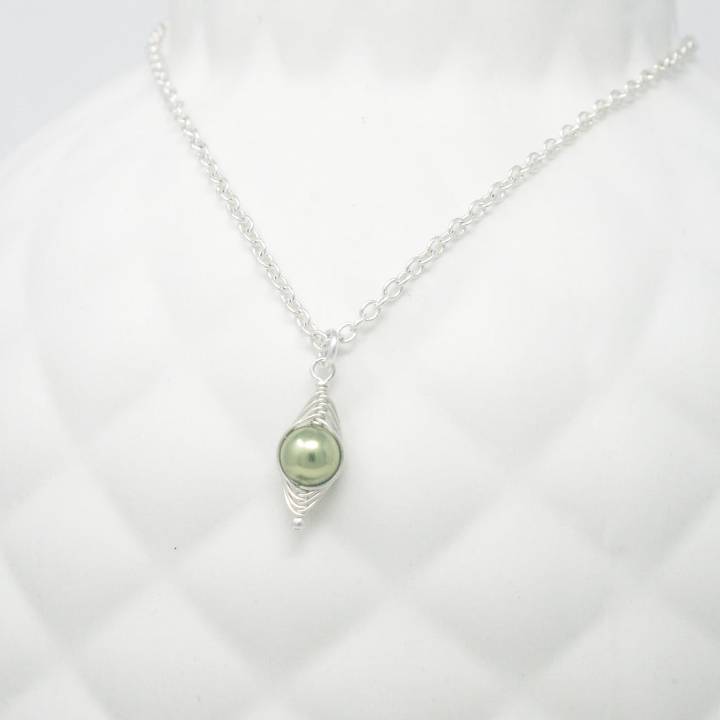 a necklace with a green pearl on a chain