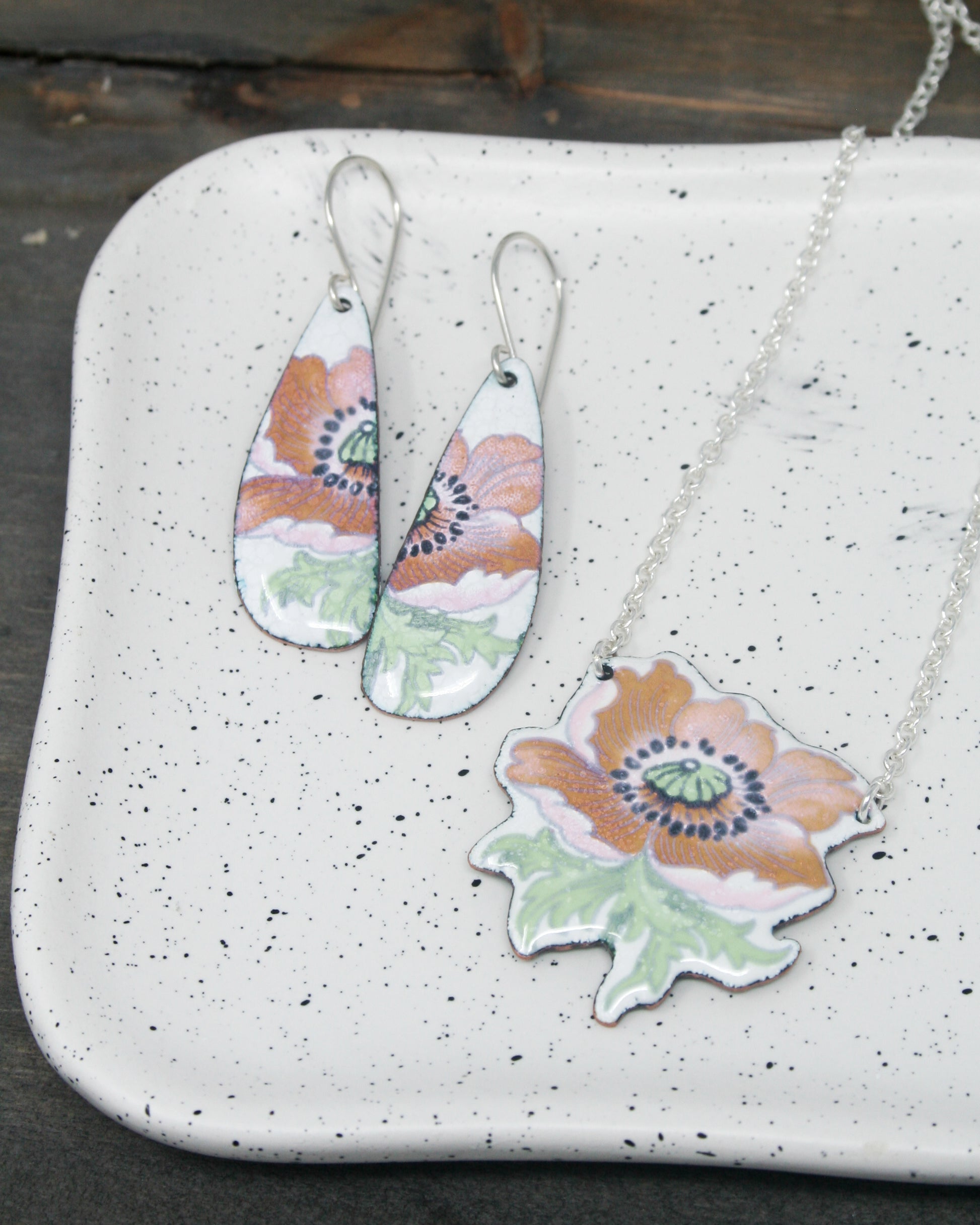 a couple of necklaces sitting on top of a white tray