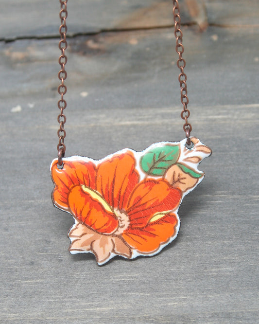 a necklace with a flower painted on it