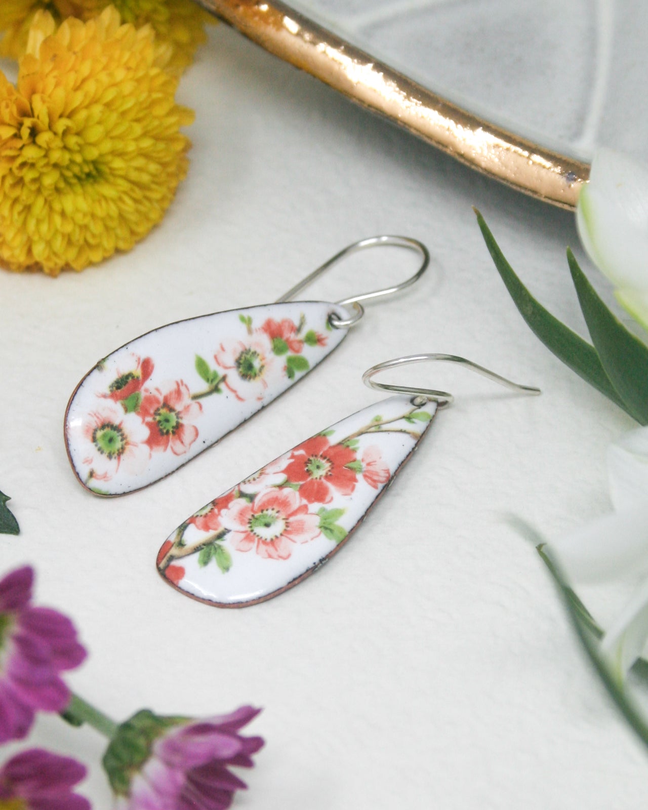 a pair of earrings sitting on top of a table