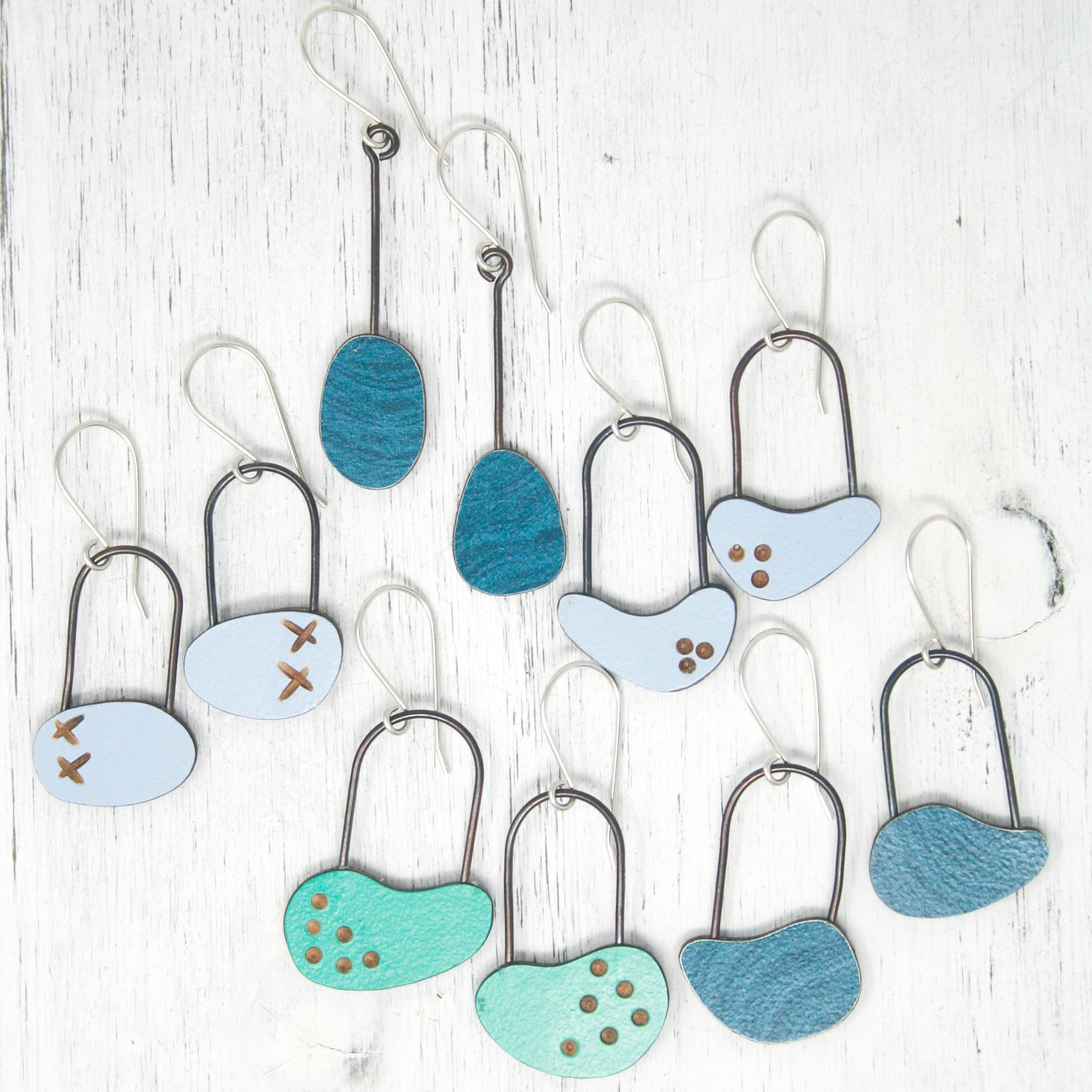 a bunch of different shaped objects hanging on a wall