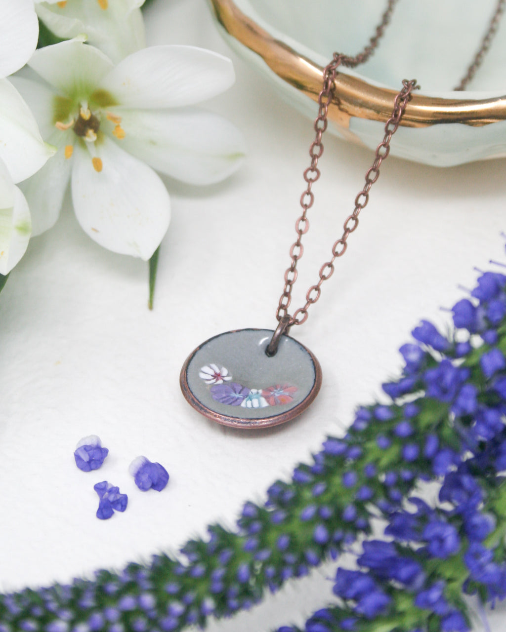 a necklace with a picture of a flower on it