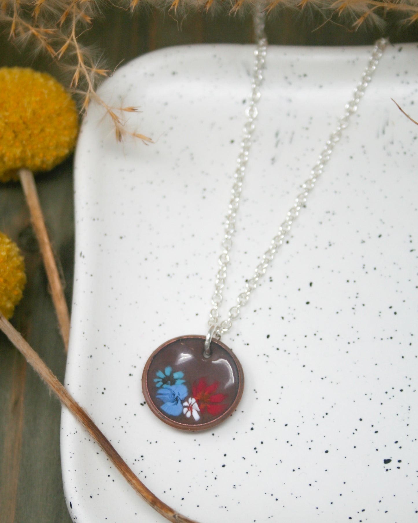 a necklace with a picture of a butterfly on it