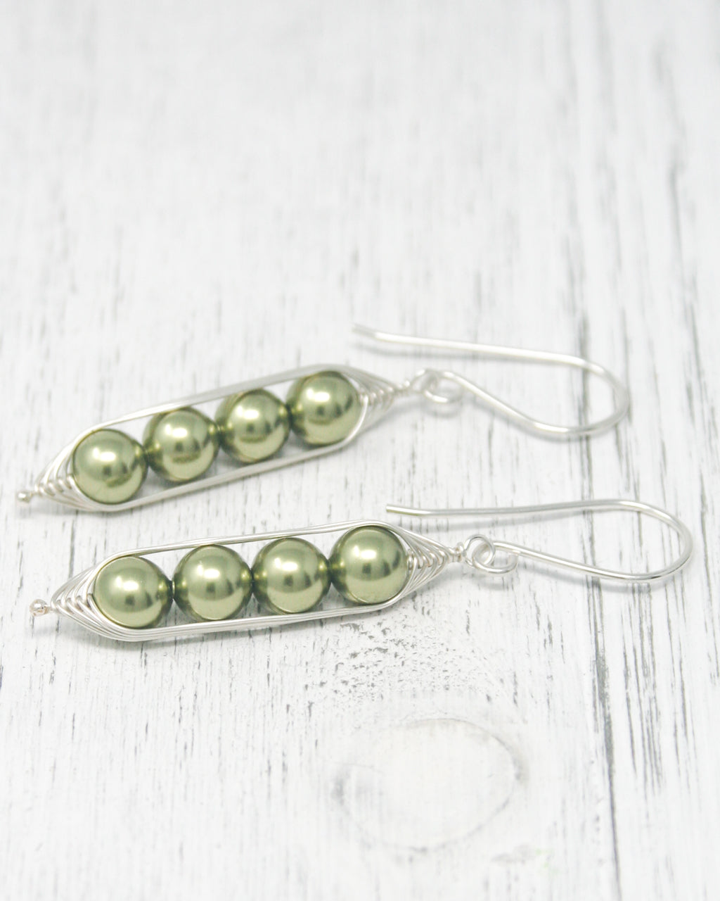 a pair of peas are shown on a white table