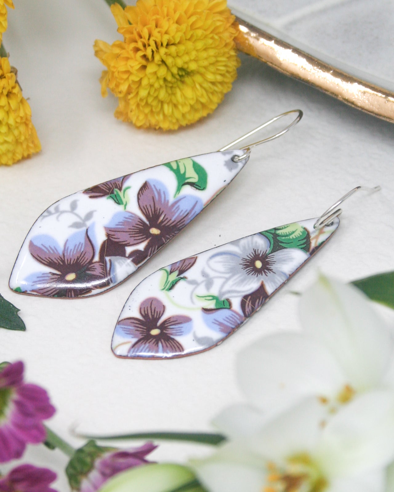 a pair of earrings sitting on top of a table