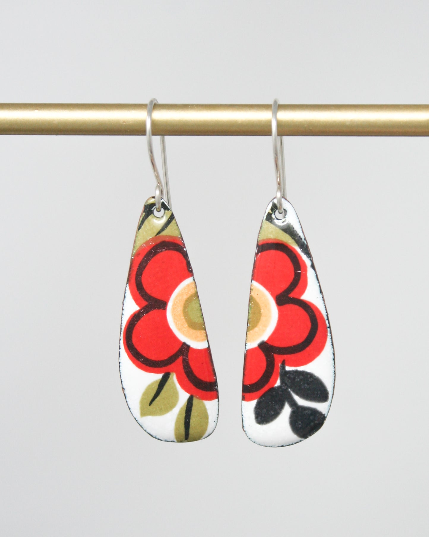 a pair of earrings hanging from a hook
