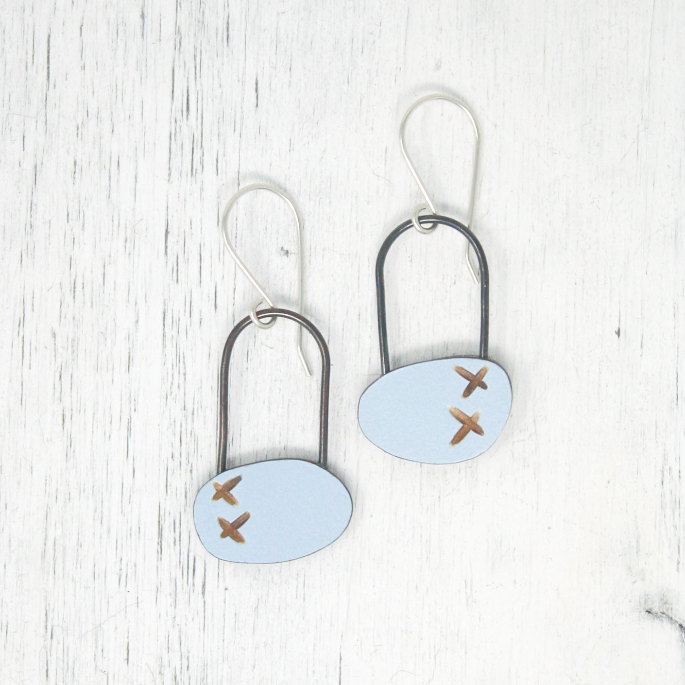 a pair of earrings with a plane on them