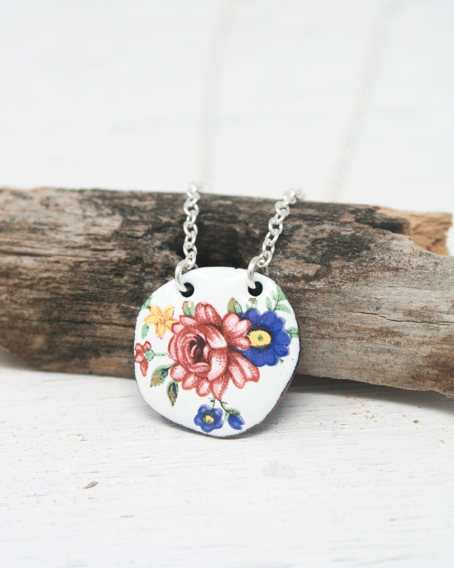 a necklace with a flower painted on it