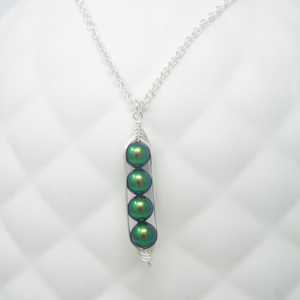 a necklace with three green beads hanging from it
