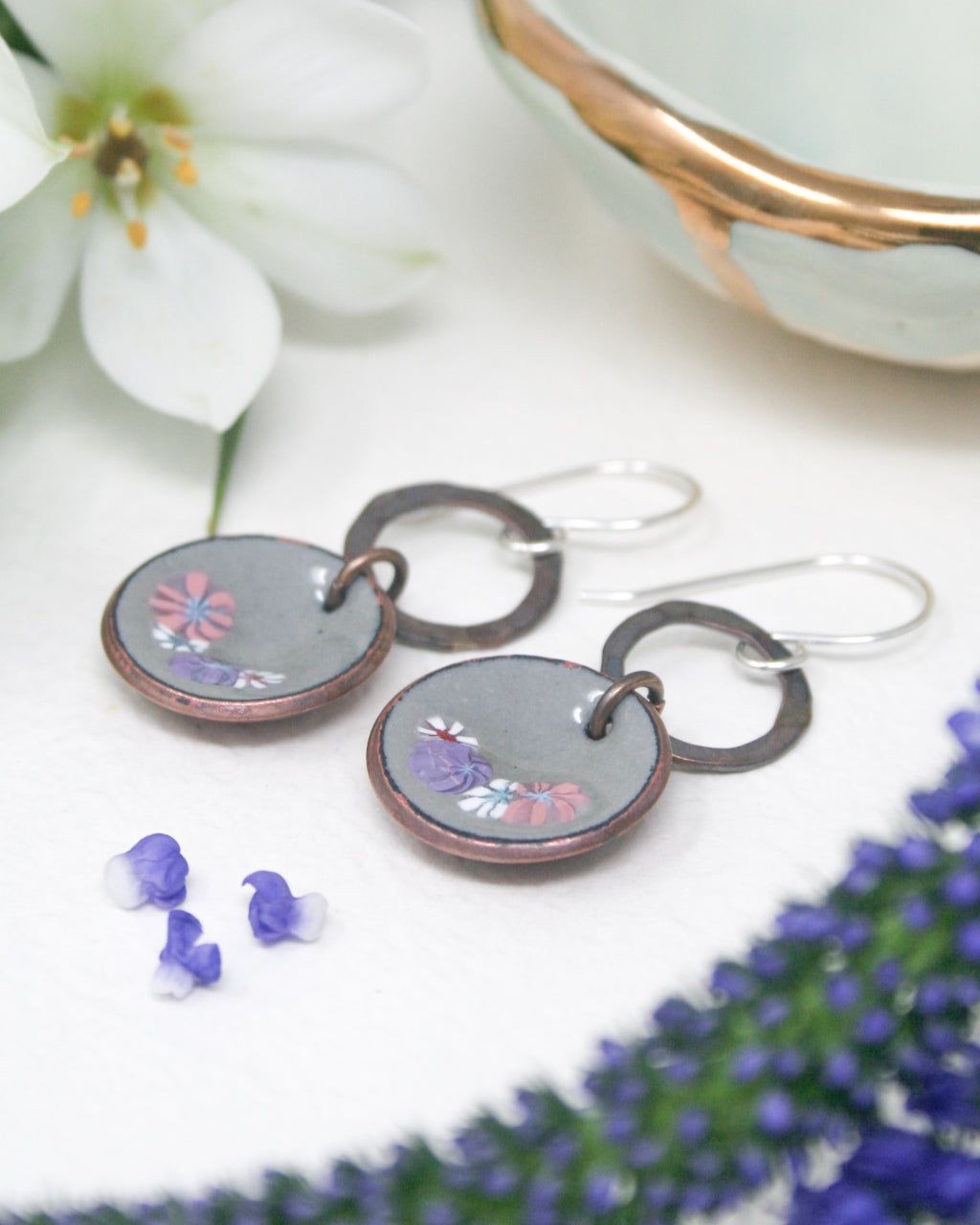 a pair of earrings sitting on top of a table