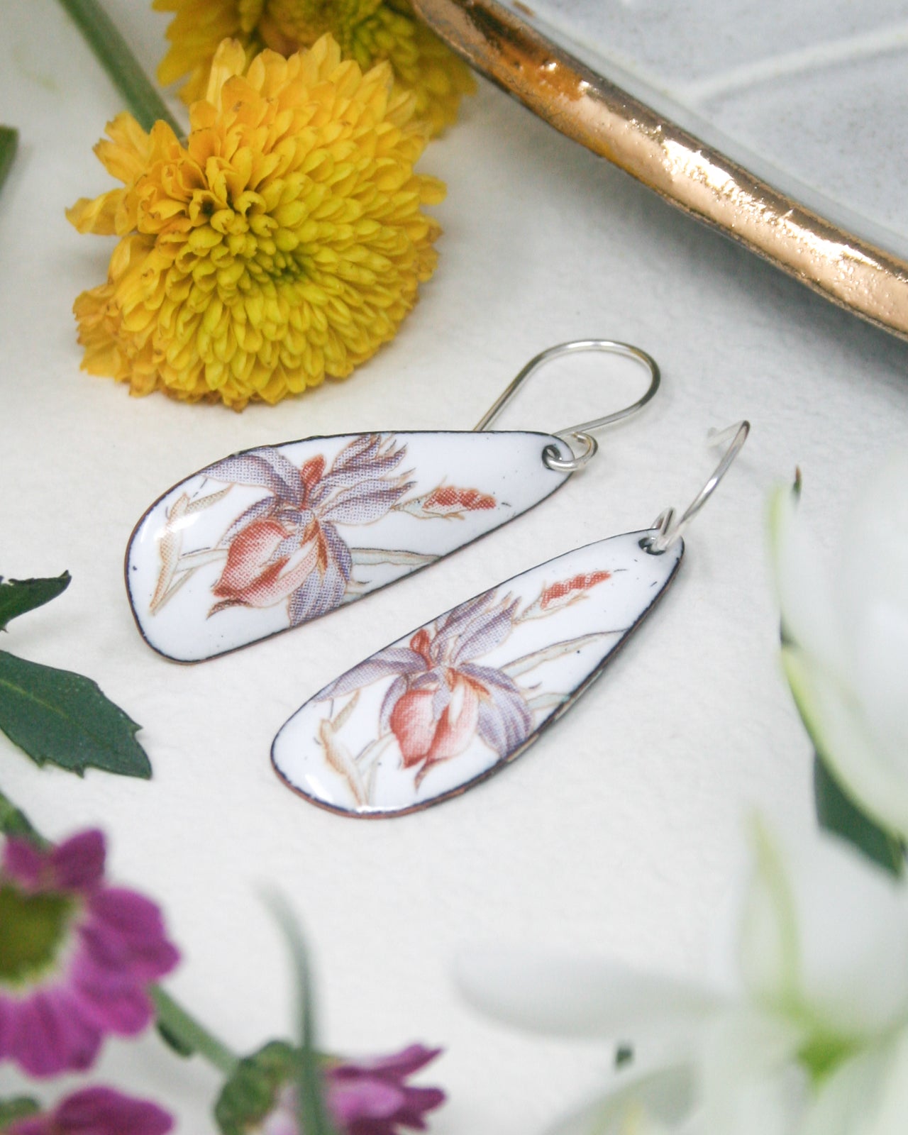 a pair of earrings sitting on top of a table