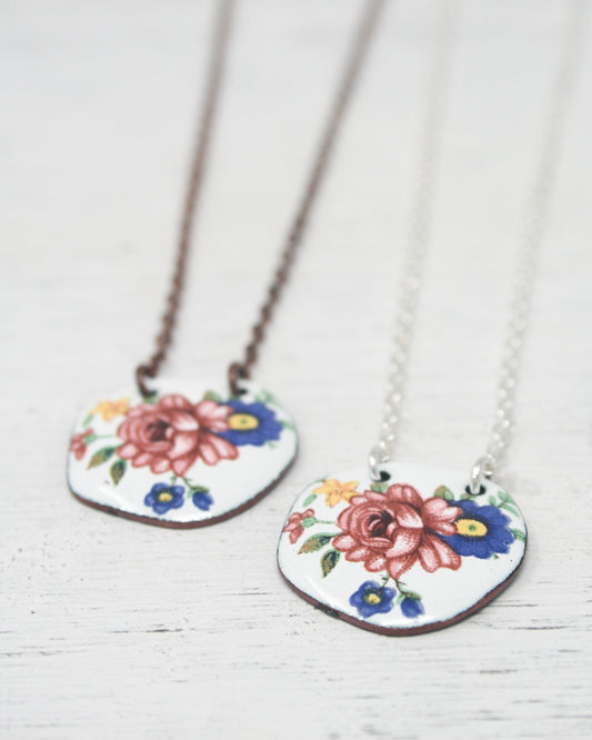a couple of necklaces with flowers on them