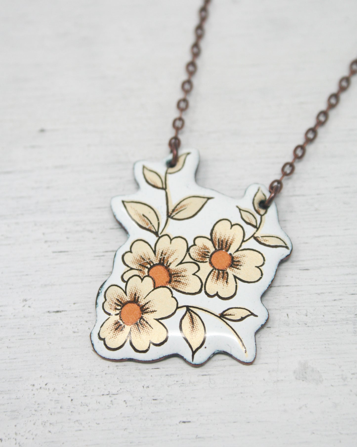 a necklace with flowers painted on it