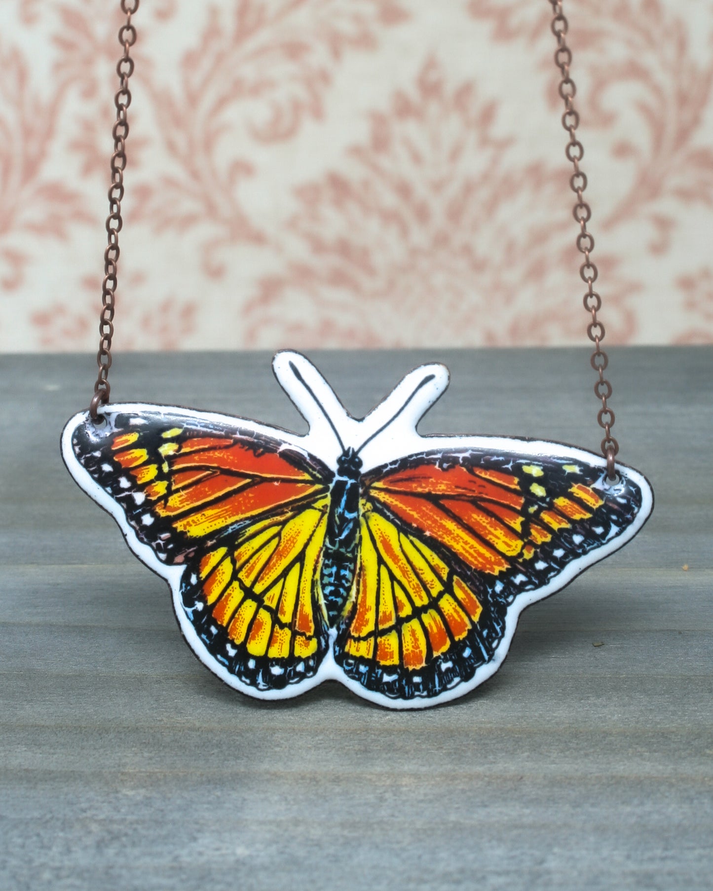 a picture of a butterfly on a chain