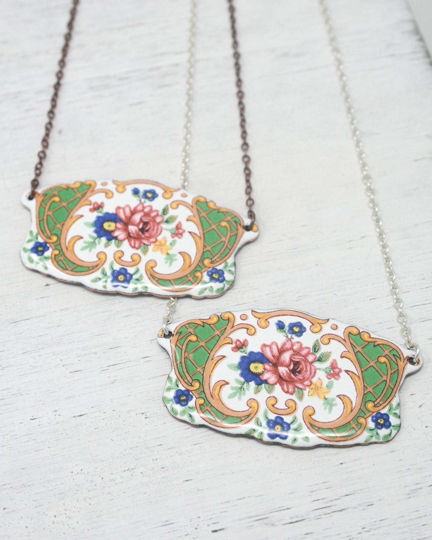 a couple of necklaces sitting on top of a table