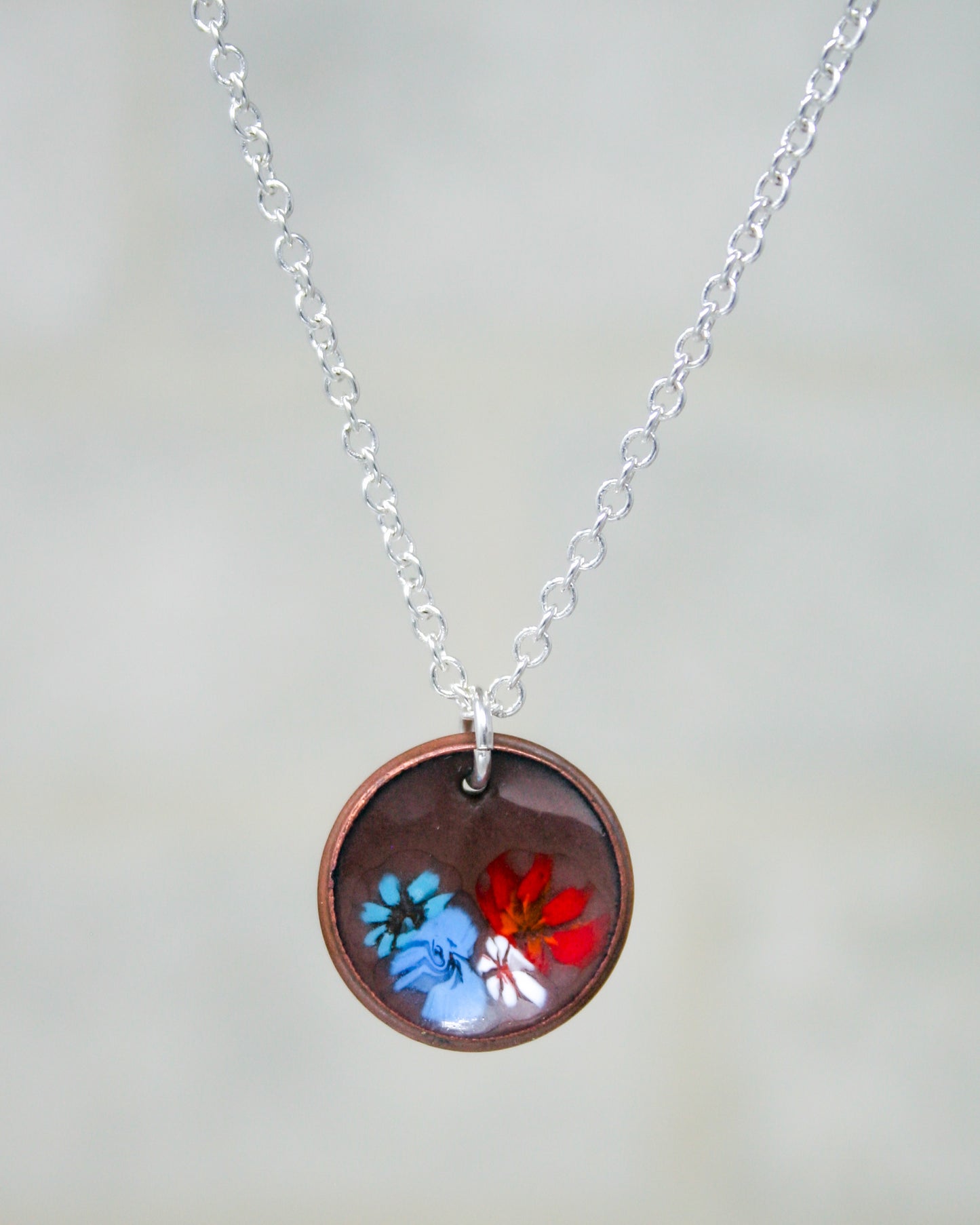 a necklace with a picture of two butterflies on it