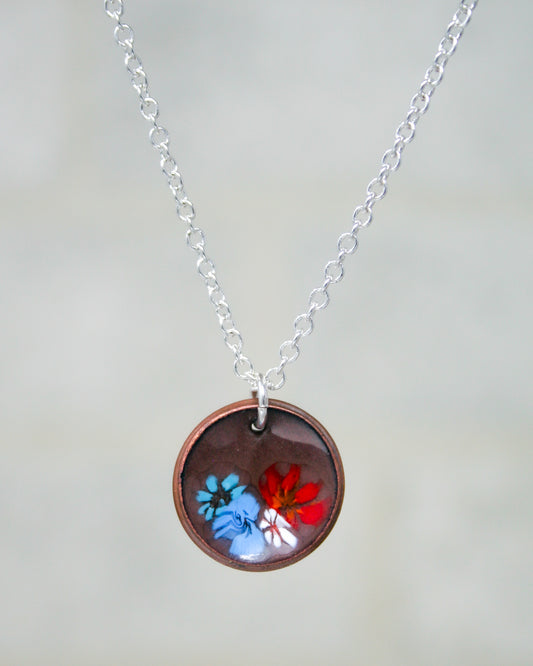 a necklace with a picture of two butterflies on it