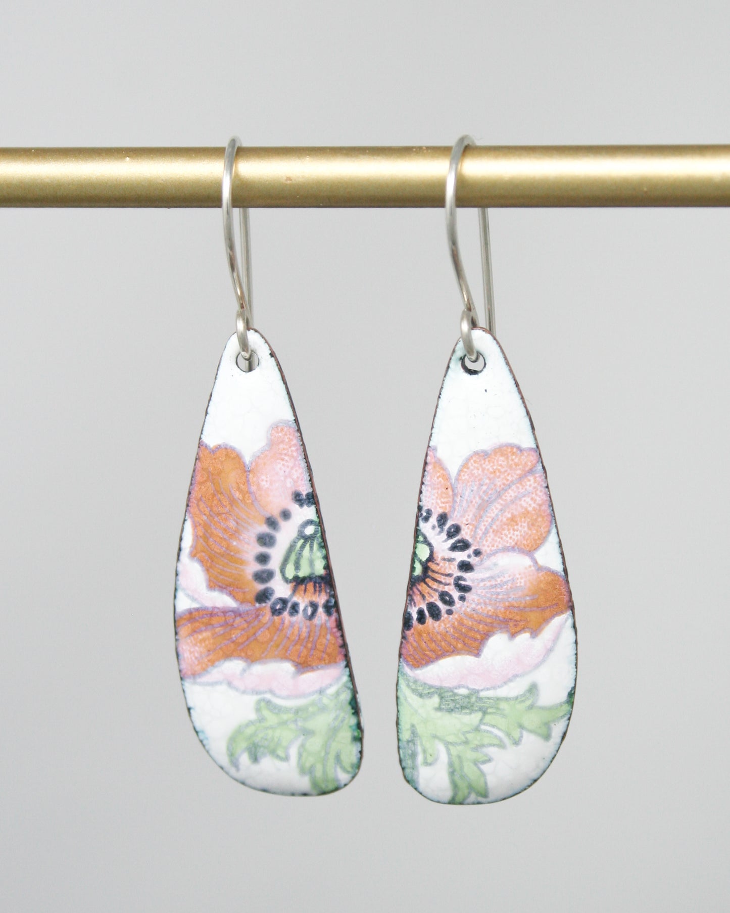a pair of earrings hanging from a hook