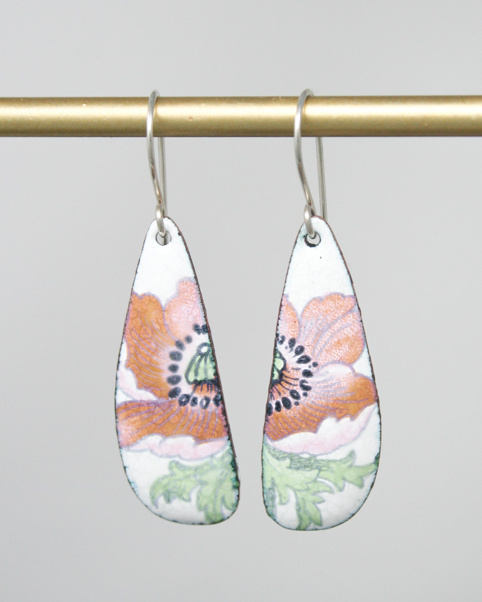 a pair of earrings hanging from a hook