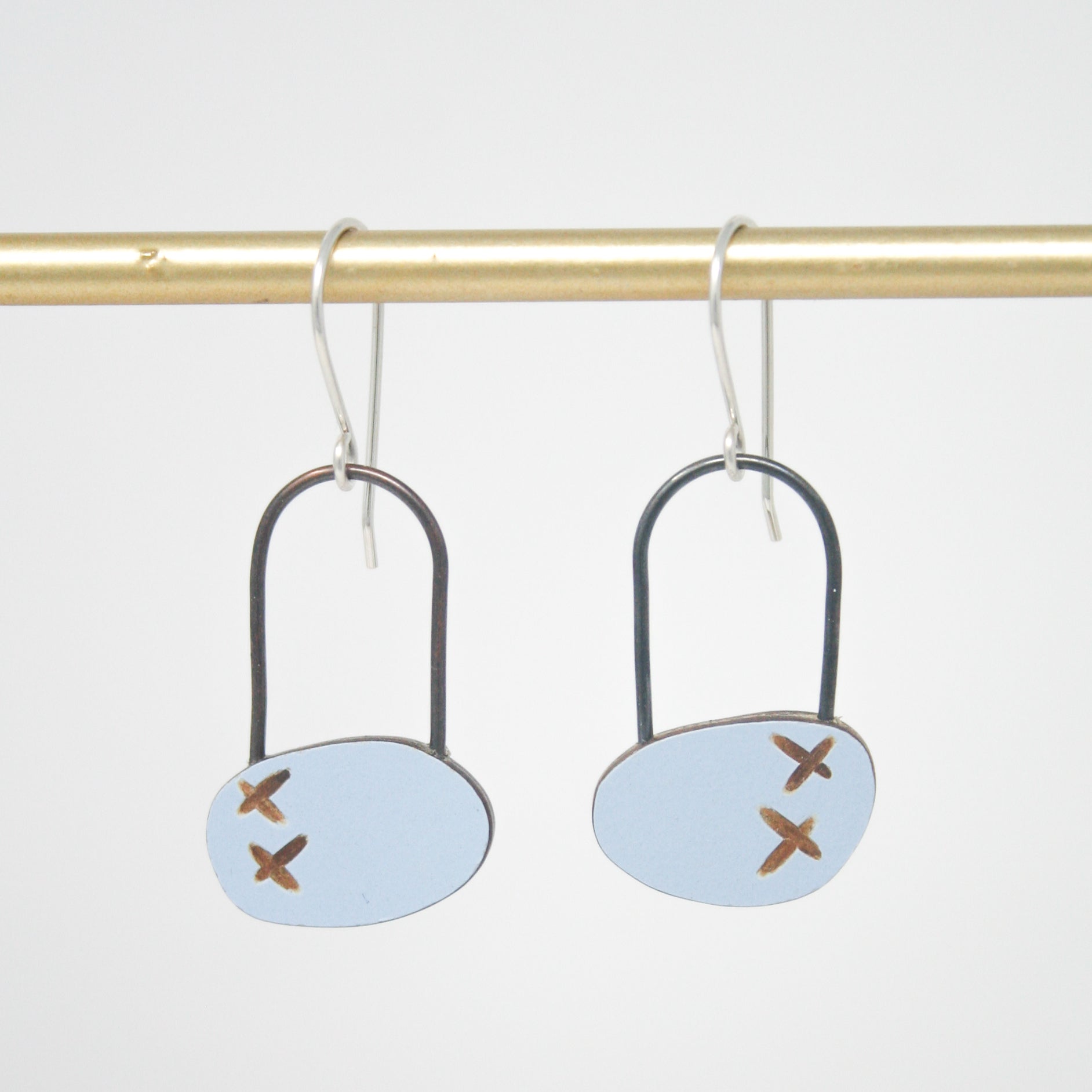 a pair of earrings with crosses on them
