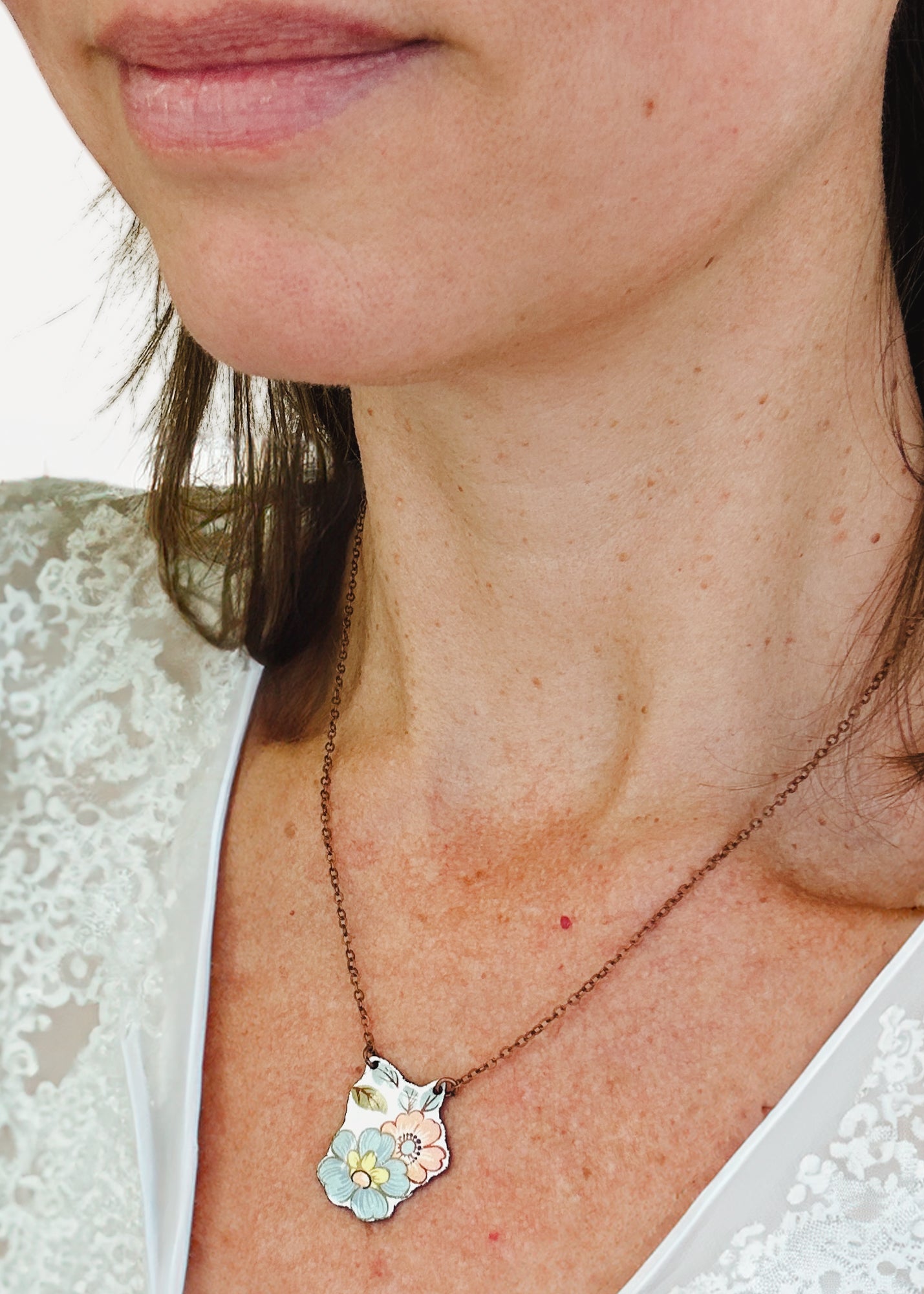 a close up of a person wearing a necklace