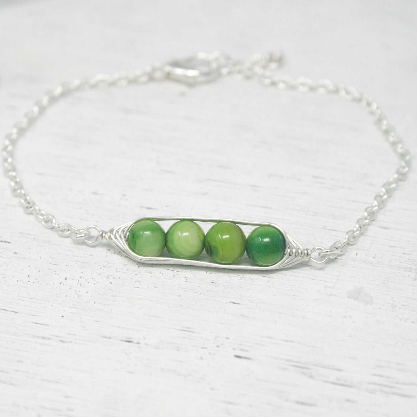 three peas in a pod on a chain bracelet