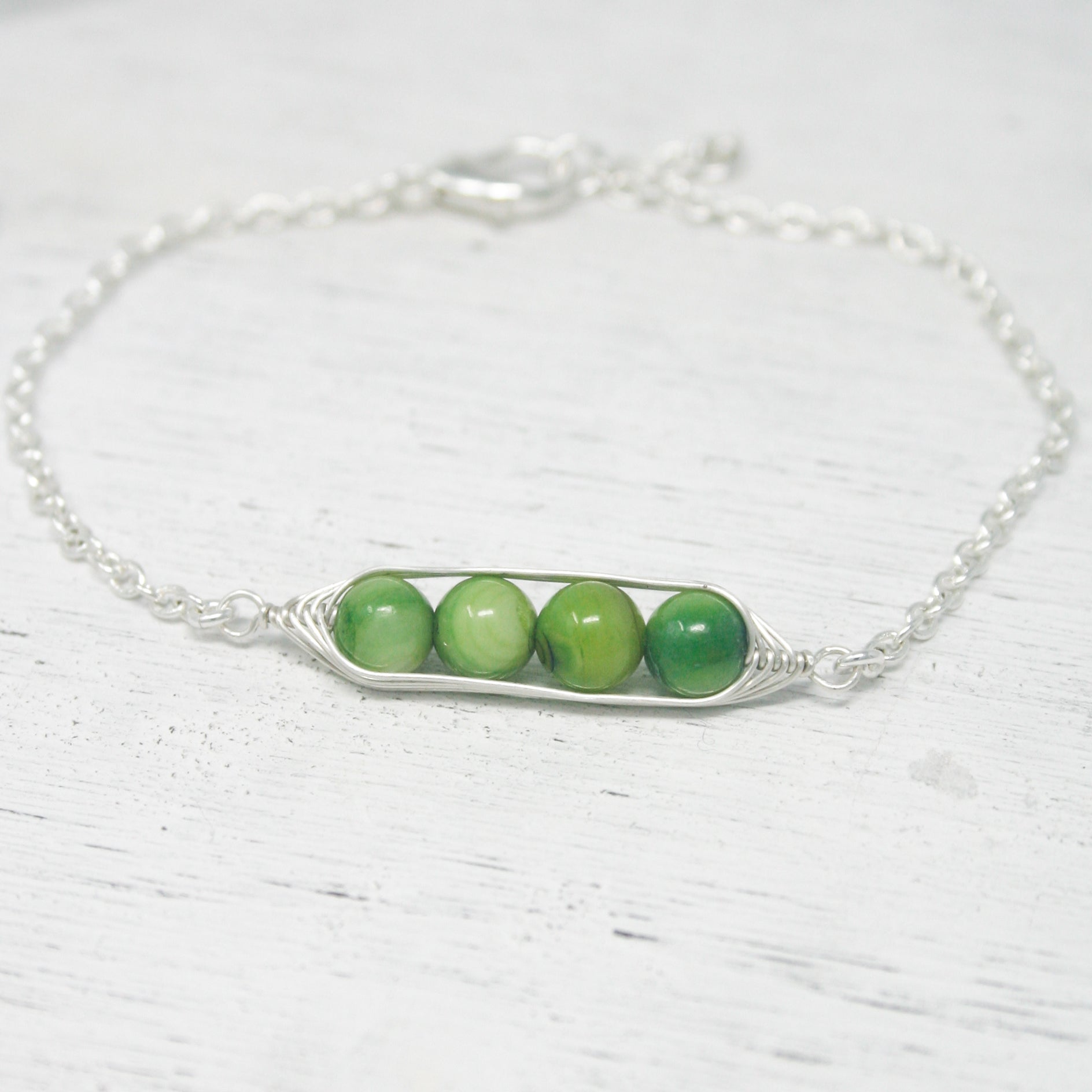 three peas in a pod on a chain bracelet