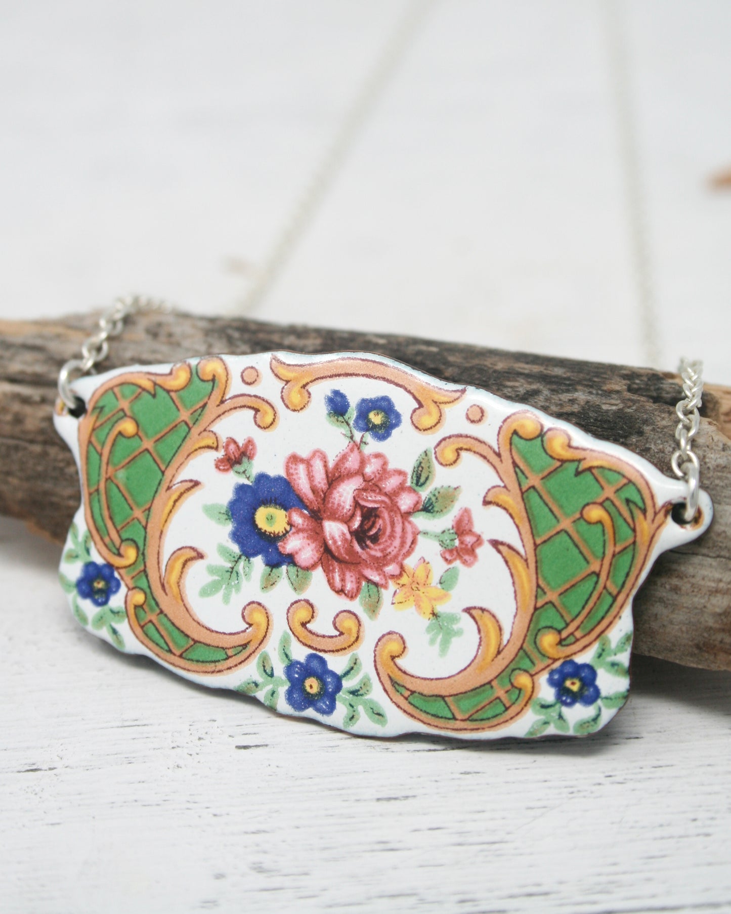 a close up of a piece of wood with a flower painted on it