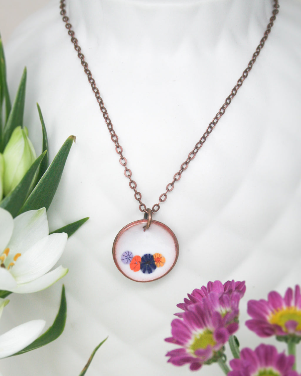 a necklace with a flower in the middle of it