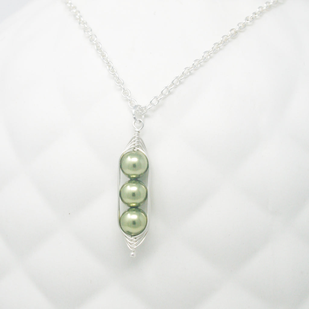 three peas in a pod on a chain