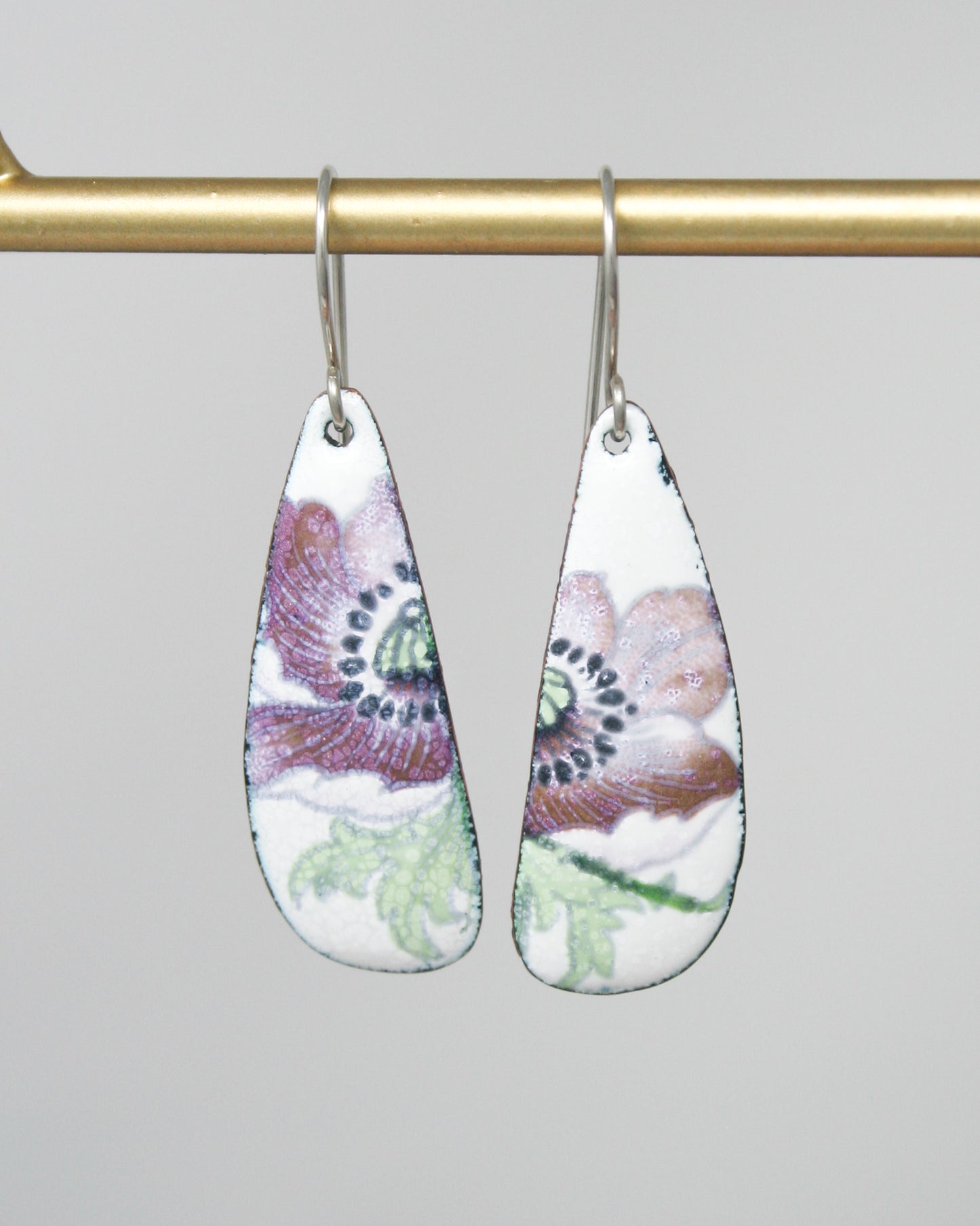 a pair of earrings hanging from a hook