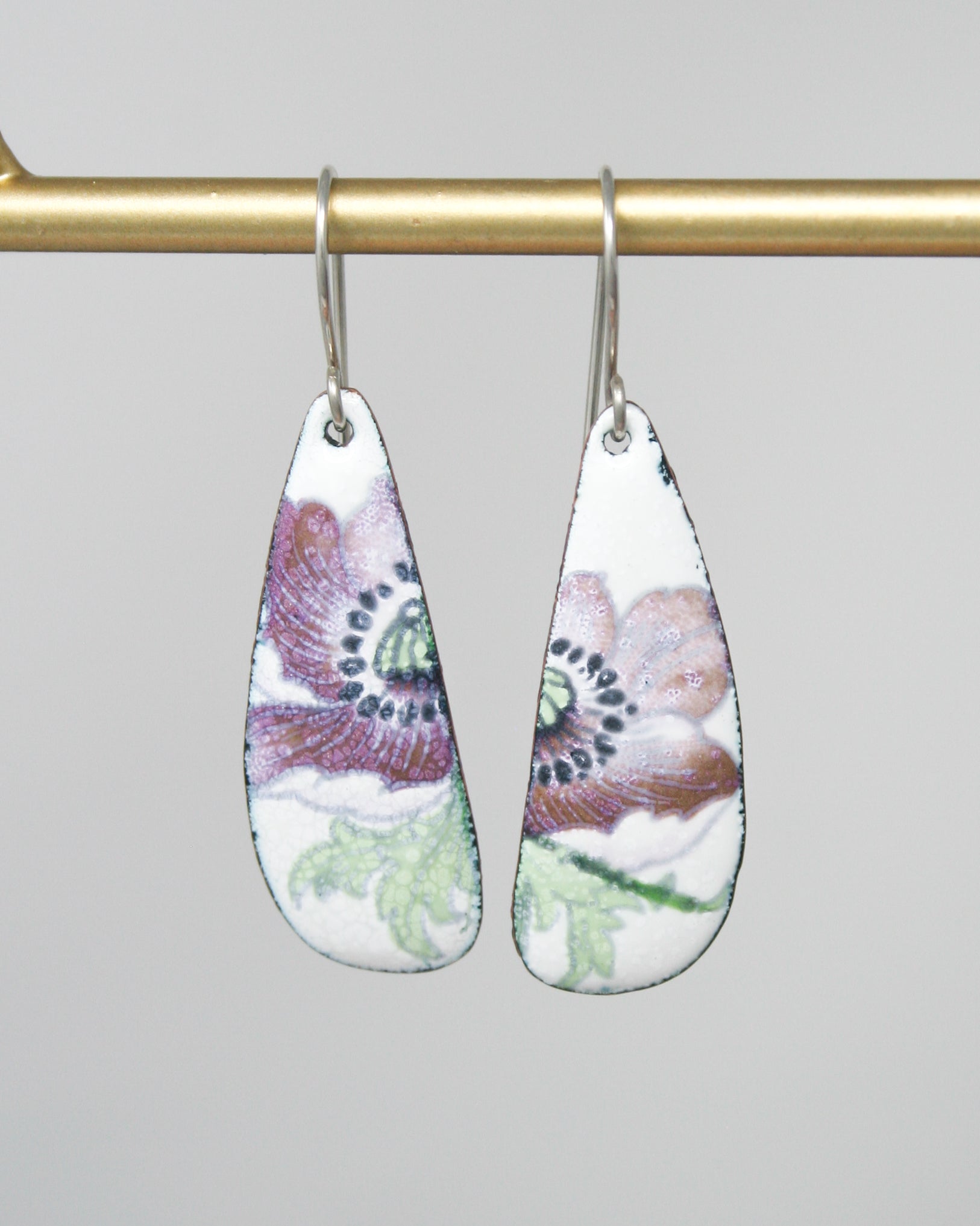 a pair of earrings hanging from a hook