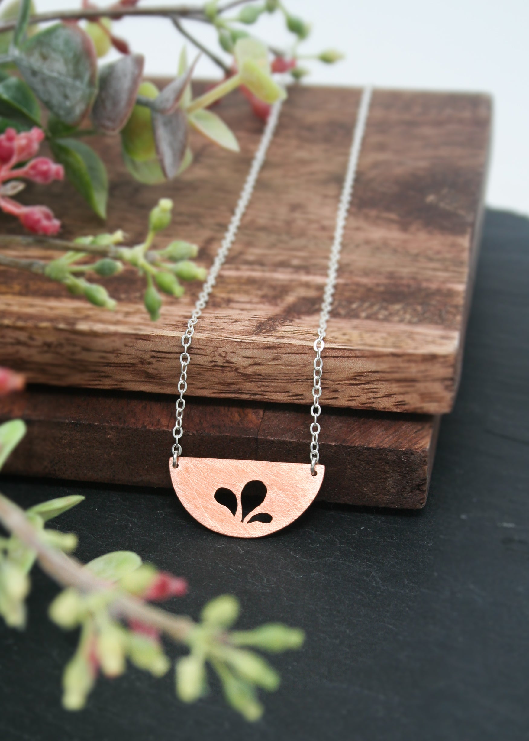 a necklace that has a flower on it