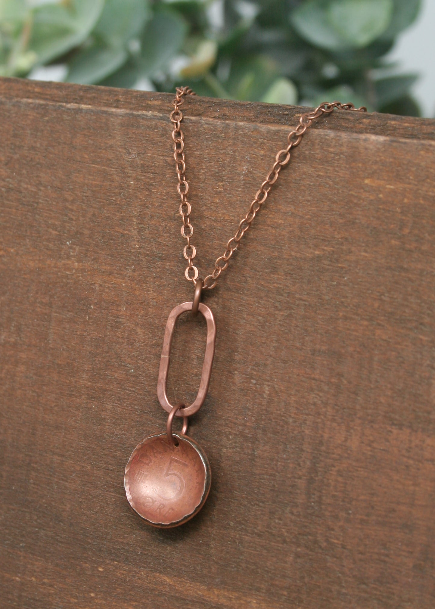 a close up of a necklace on a wooden surface