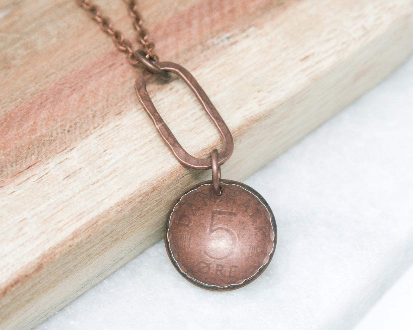 a close up of a necklace on a wooden surface