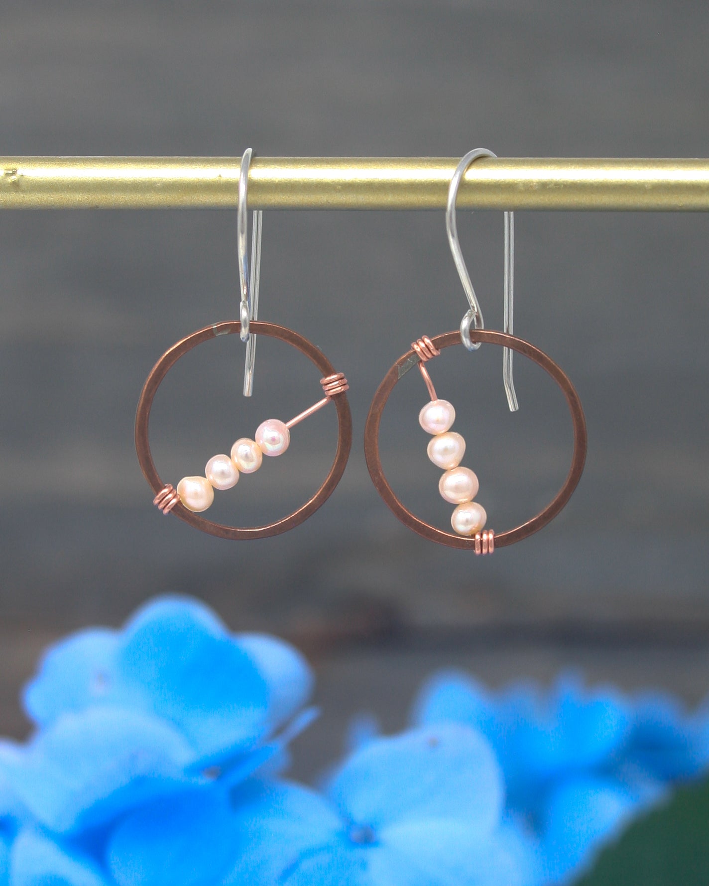 a pair of hoops with pearls hanging from them