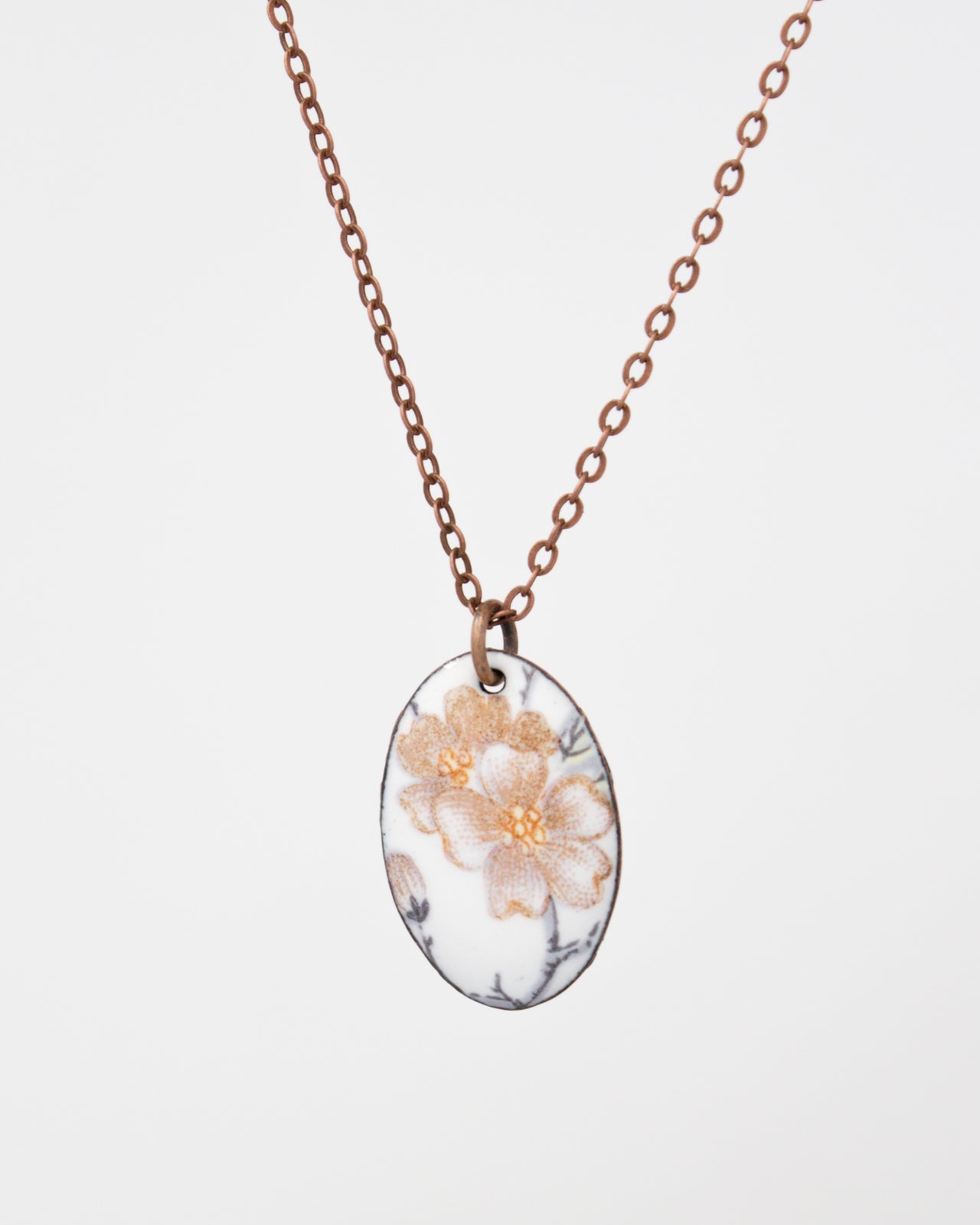 A necklace with a pendant featuring a floral design.