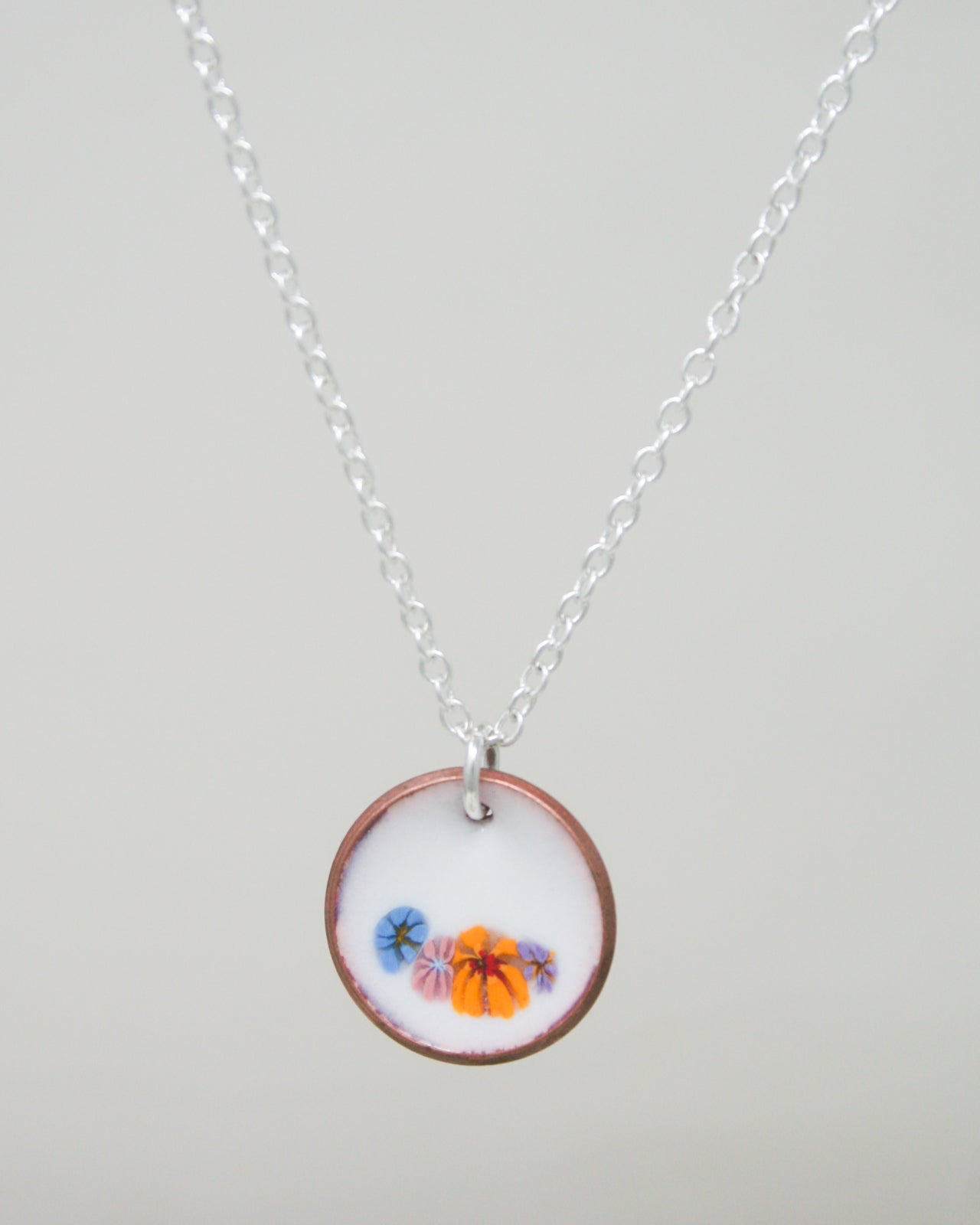 a necklace with a picture of a beach scene on it