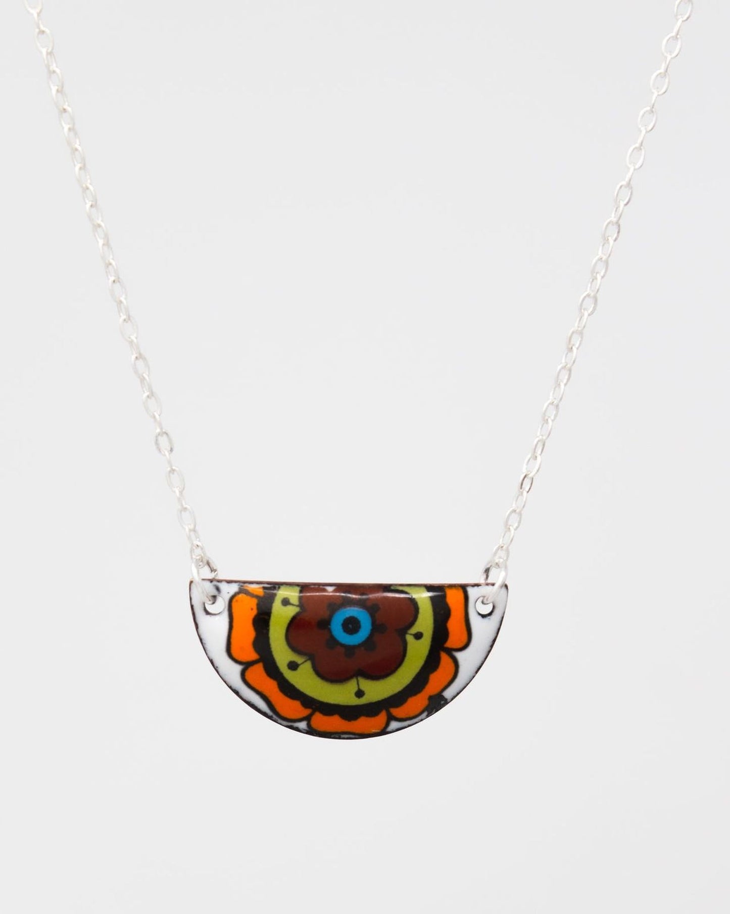 A colorful pendant necklace with a floral design on the center.