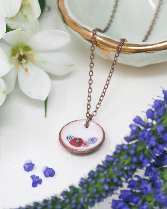 a necklace with a picture of a bee on it